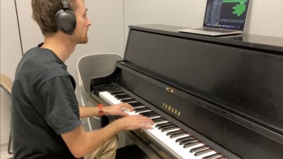 instructor Dominic playing piano