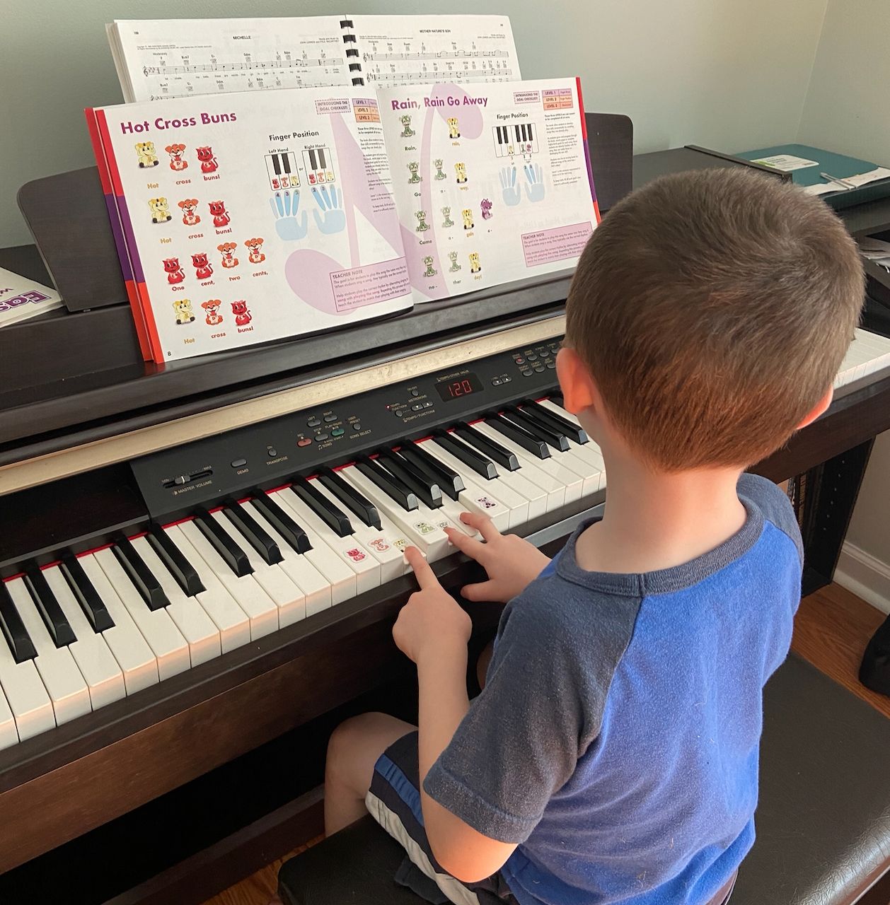 child playing piano with Note-Making for Piano book