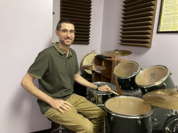 Music instructor Bryan at a drum kit